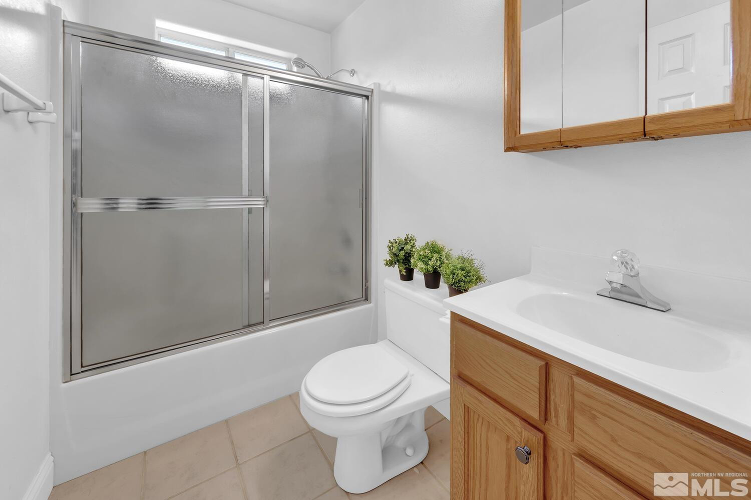 1031 University Ridge Drive Reno, NV 89512 - Photo 25 of 38 a bathroom with a sink a toilet and shower