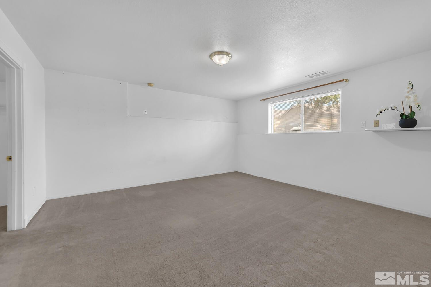 1031 University Ridge Drive Reno, NV 89512 - Photo 27 of 38 a view of an empty room with a window