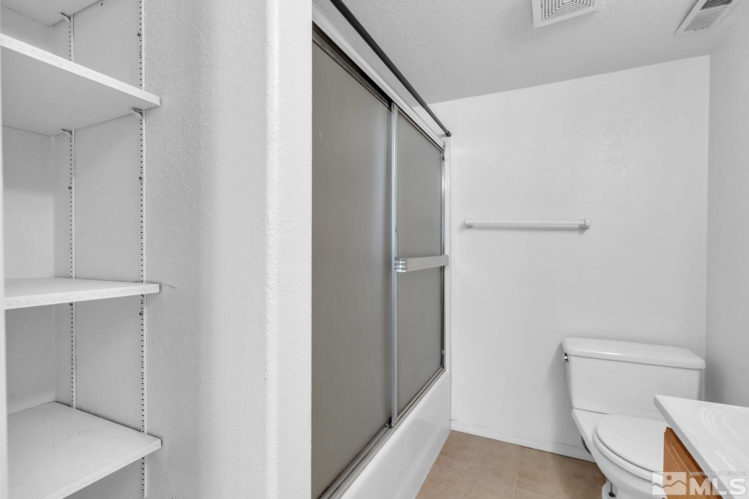 1031 University Ridge Drive Reno, NV 89512 - Photo 31 of 38 a bathroom with a toilet and a shower