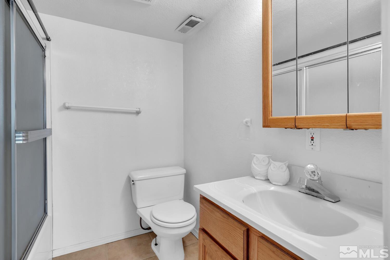 1031 University Ridge Drive Reno, NV 89512 - Photo 32 of 38 a bathroom with a sink toilet and vanity