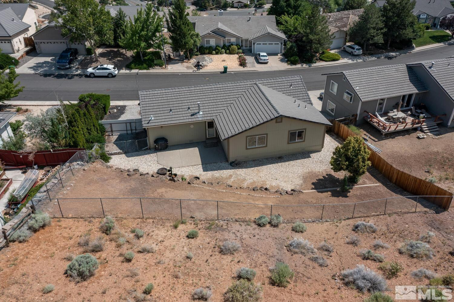 1031 University Ridge Drive Reno, NV 89512 - Photo 36 of 38 an aerial view of a house with a yard and sitting area