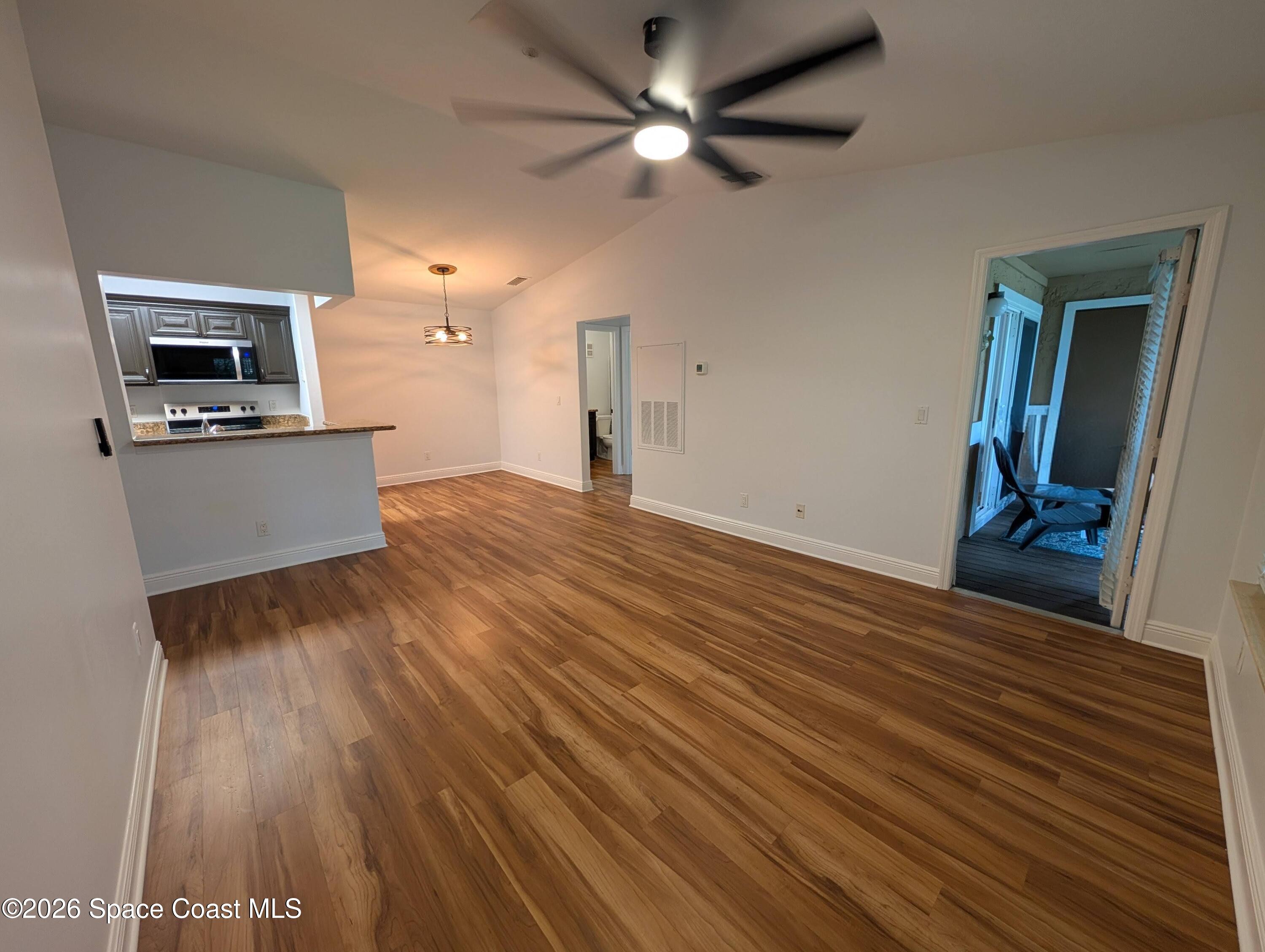 7667 North Wickham Road, Unit 818 Melbourne, FL 32940 - Photo 3 of 29 a view of empty room with wooden floor and fan