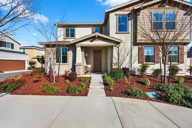 a front view of a house with garden