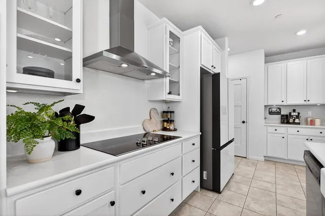 a large kitchen with a table and chairs
