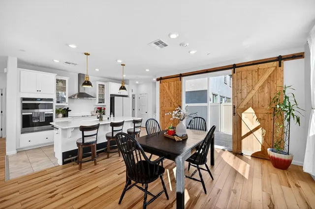 a view of a dining room with furniture window and wooden floor