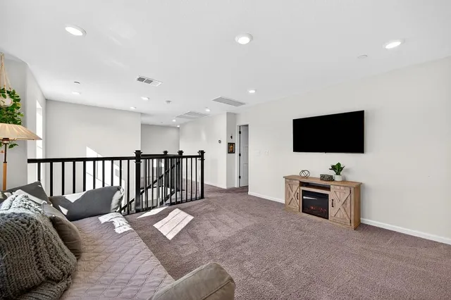 a spacious bedroom with a bed and a window