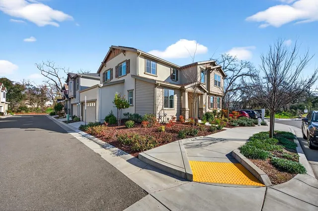 a front view of house with yard and trees around