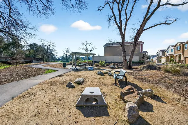 a view of a patio with a table and chairs and potted plants