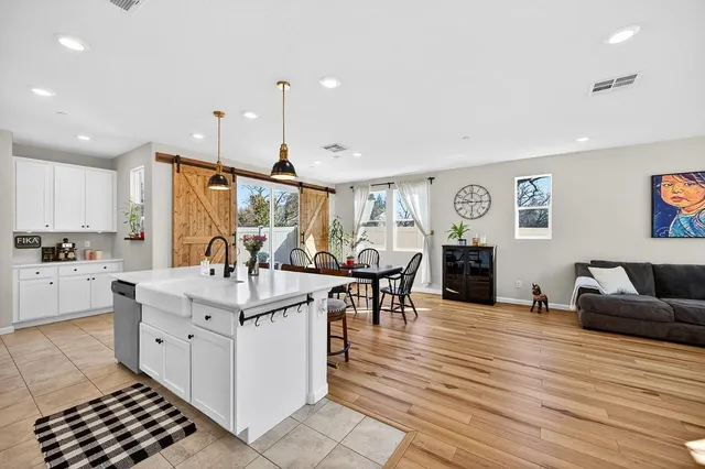 a kitchen with stainless steel appliances kitchen island granite countertop a refrigerator and a stove top oven