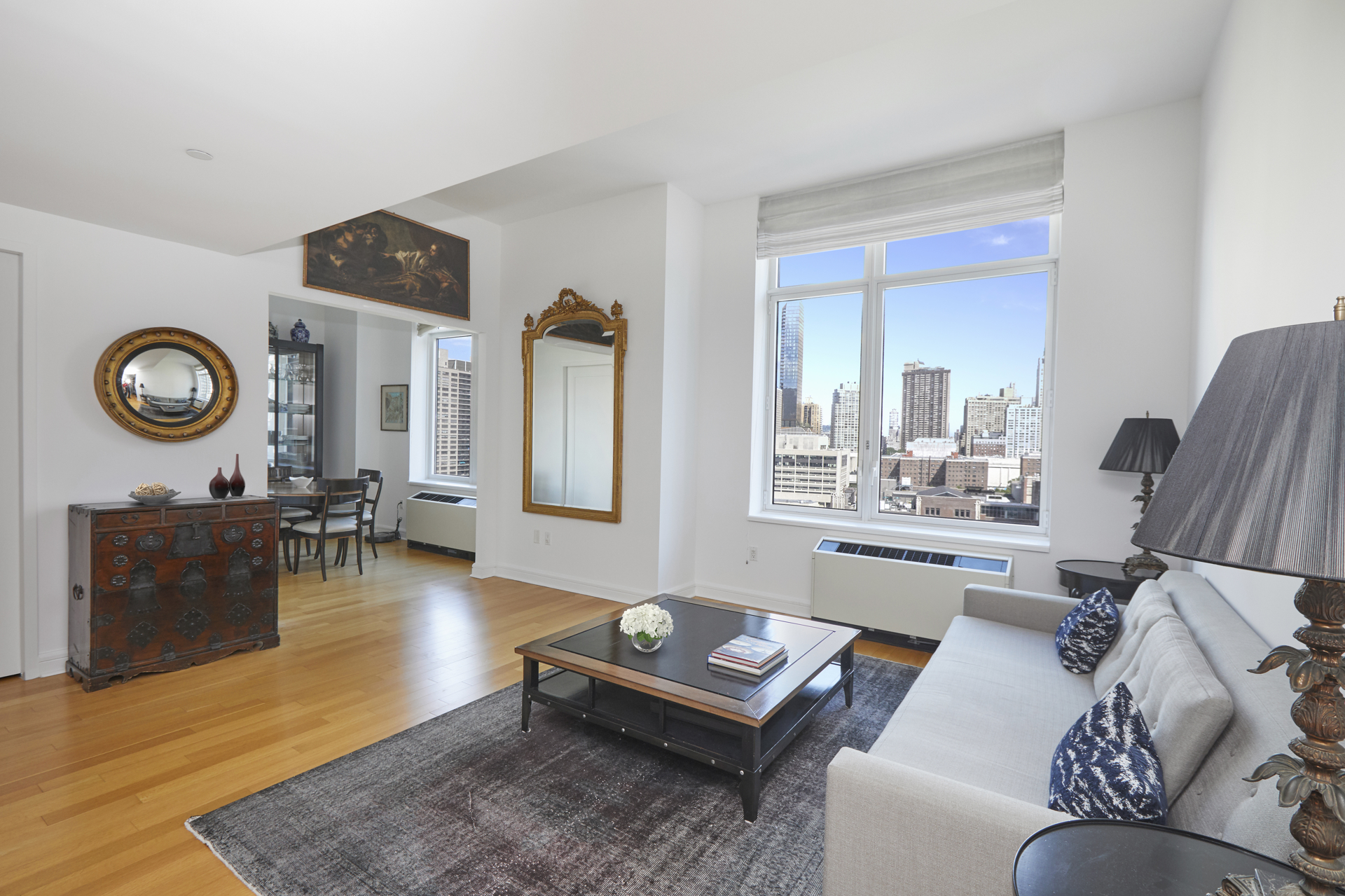 80 Riverside Boulevard, Unit 19B Manhattan, NY 10069 - Photo 2 of 18 a living room with furniture a rug and a large window