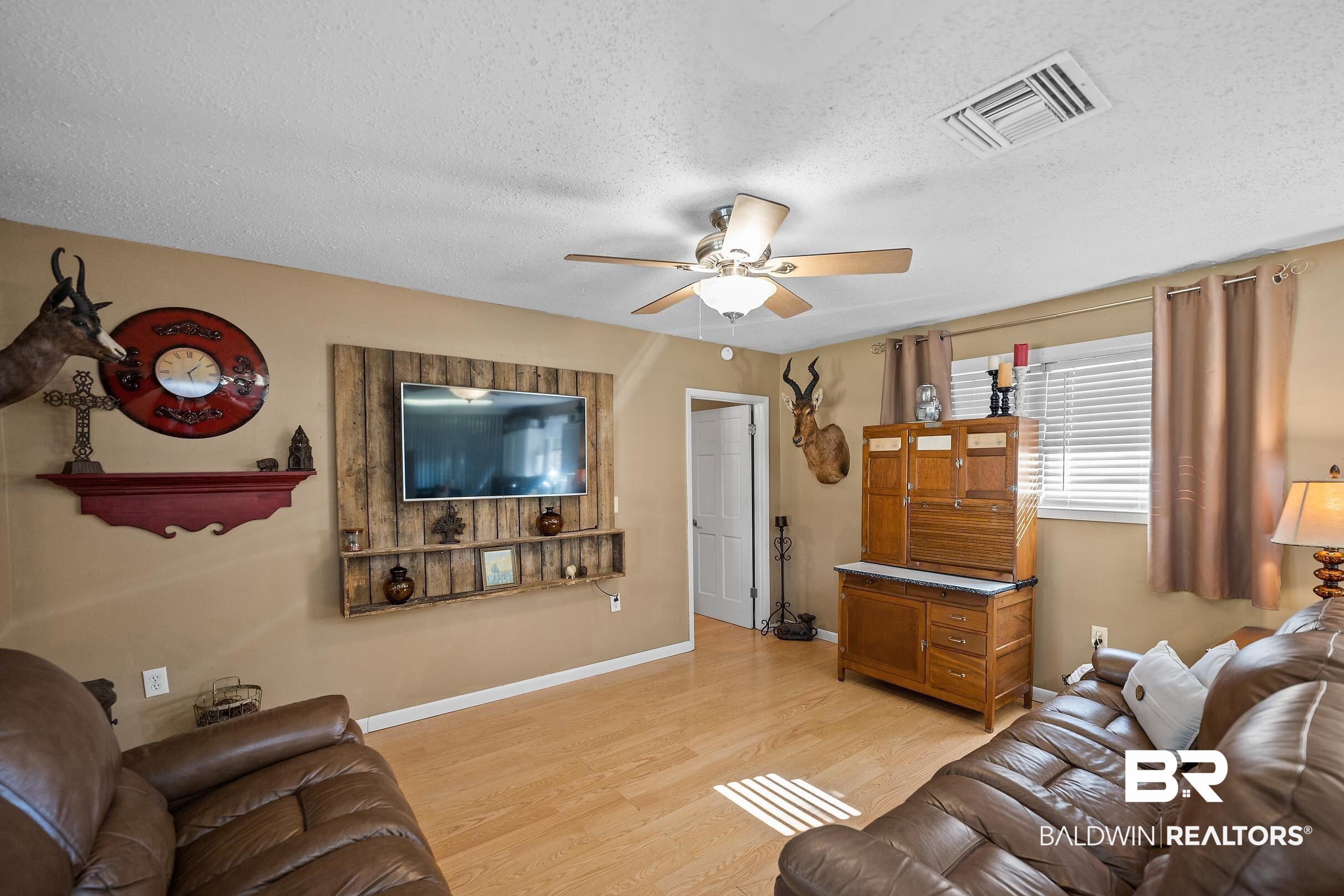 110 Sam Jones Road Atmore, AL 36502 - Photo 12 of 47 Living area with ceiling fan, a textured ceiling, and light wood-style floors