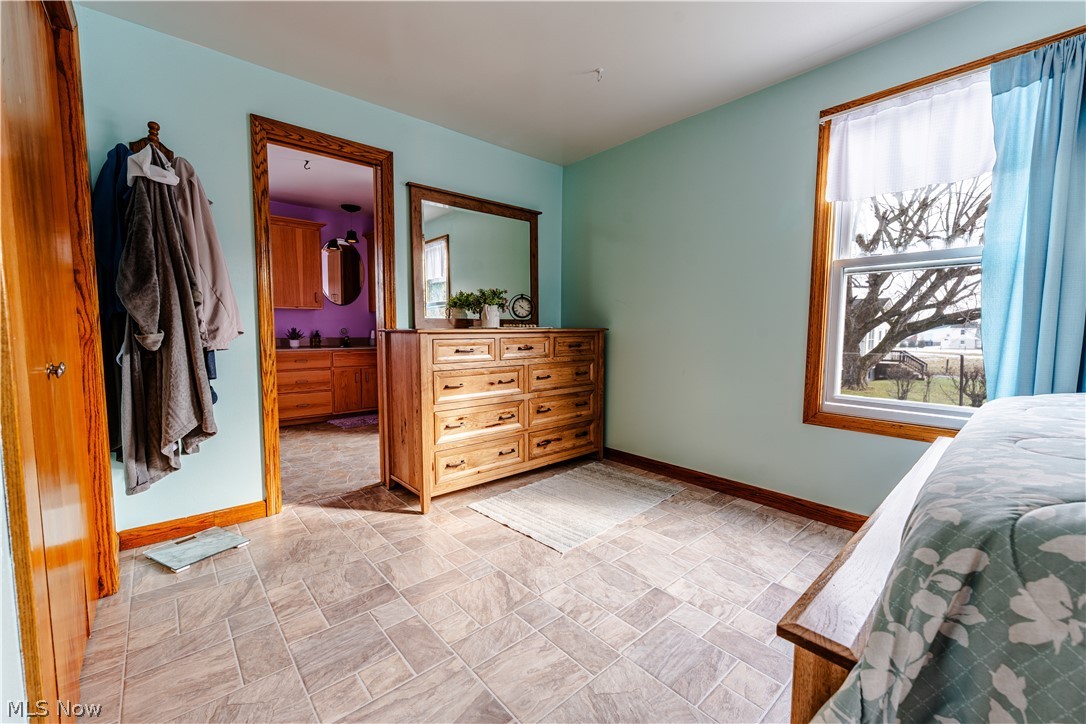16350 Nauvoo Road Middlefield, OH 44062 - Photo 18 of 50 Bedroom with stone finish floors and ensuite bath