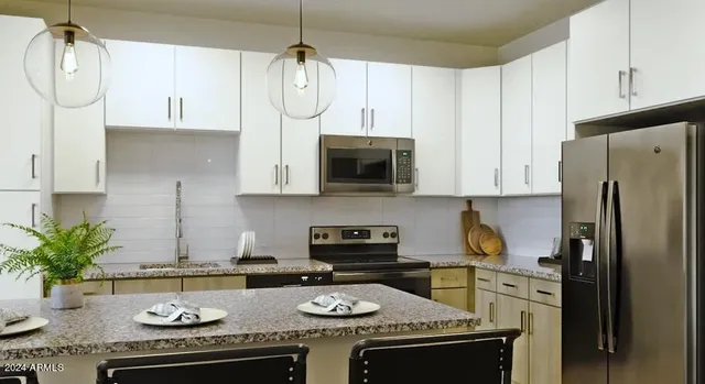 a bathroom with a granite countertop double vanity sink and mirror