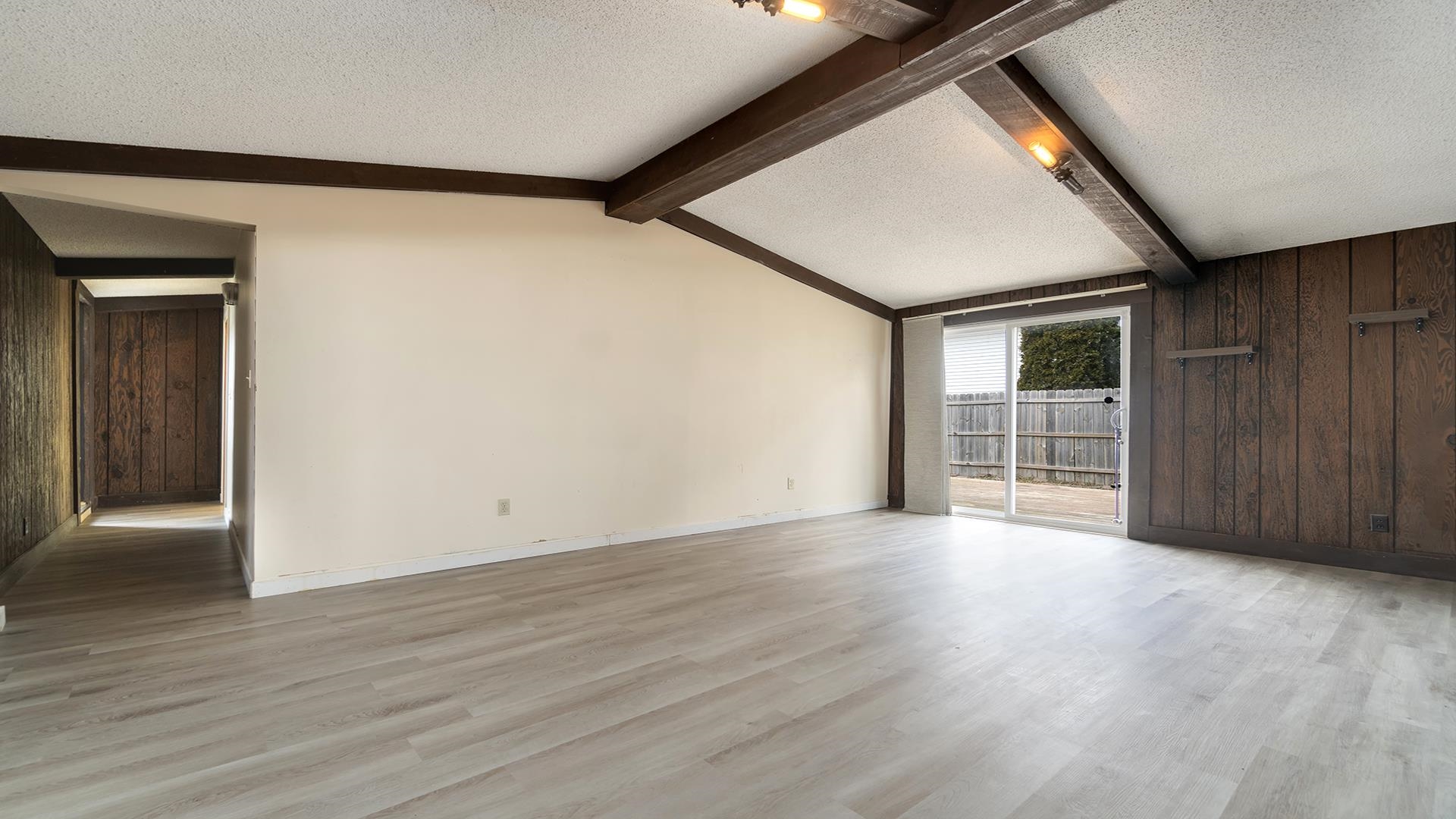 8446 South Main Street Rochelle, IL 61068 - Photo 2 of 29 a view of an empty room with wooden floor and a window