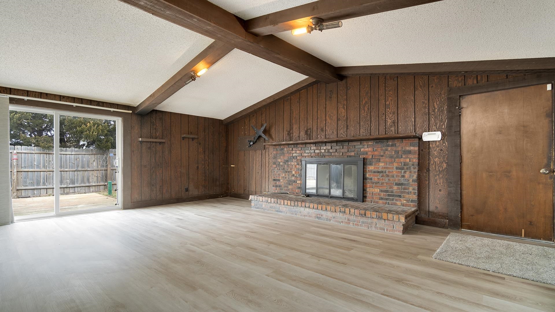 8446 South Main Street Rochelle, IL 61068 - Photo 3 of 29 a view of a livingroom with wooden floor and a fireplace