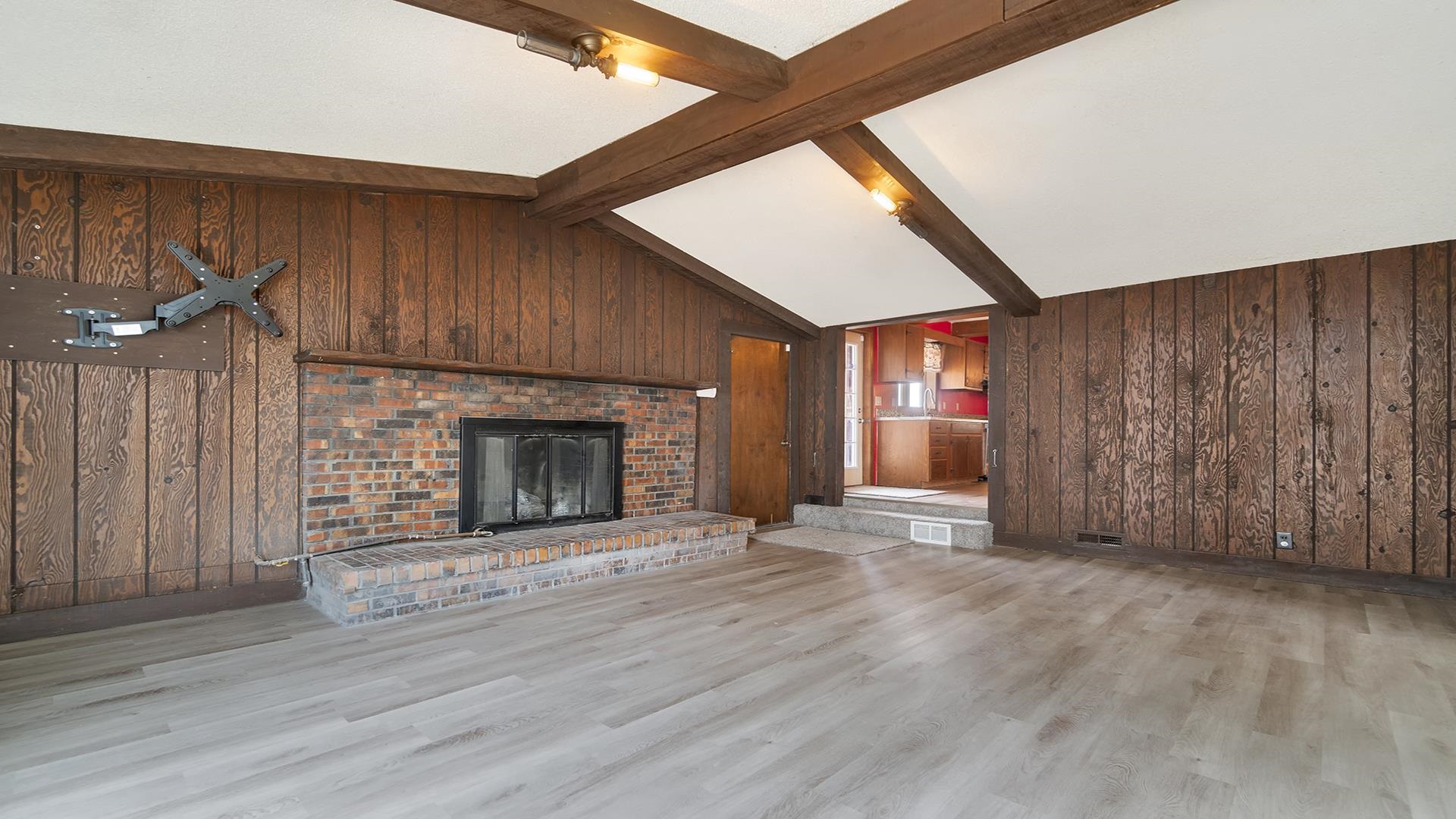 8446 South Main Street Rochelle, IL 61068 - Photo 4 of 29 a view of an empty room with wooden floor fireplace and a window