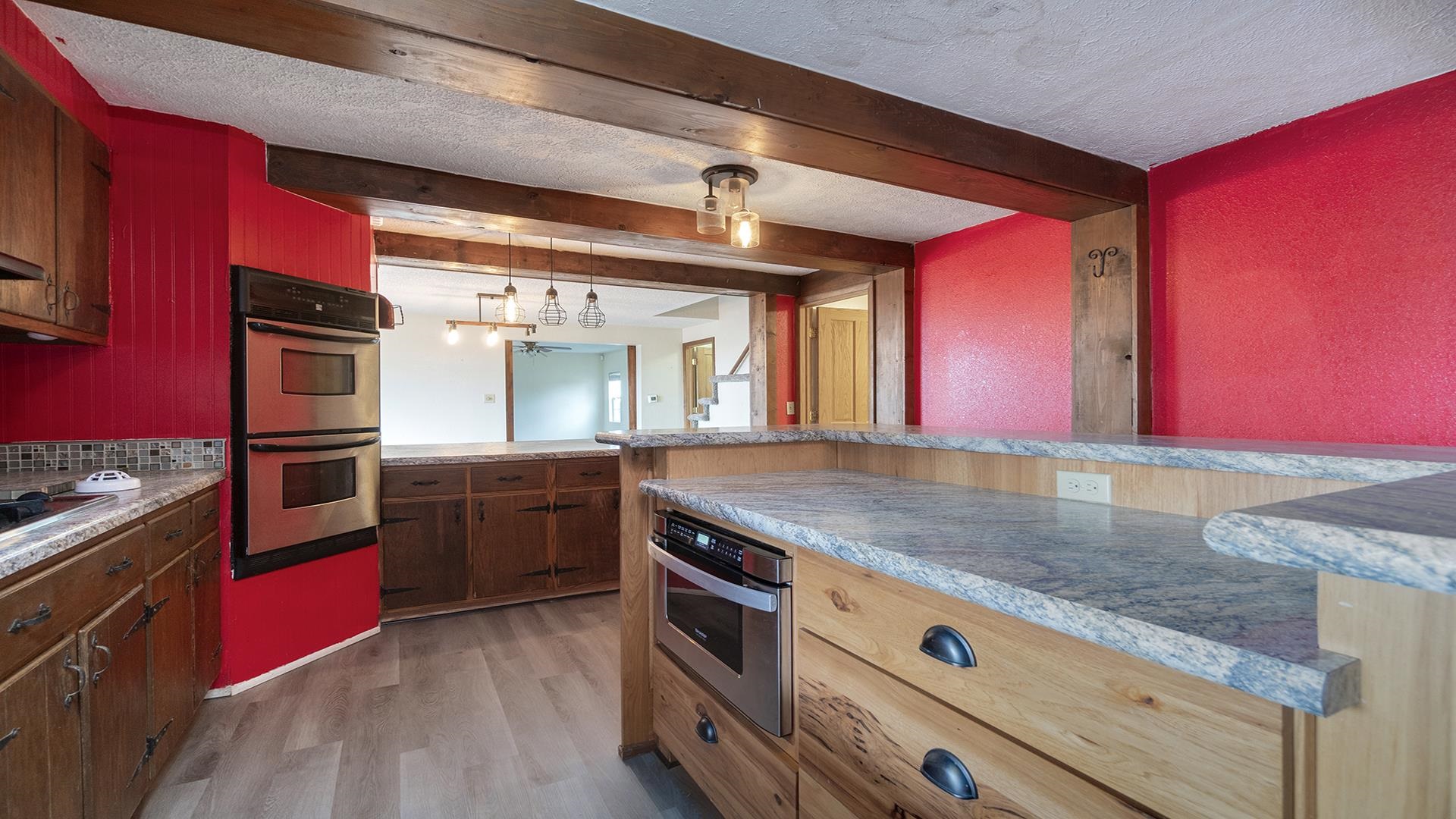 8446 South Main Street Rochelle, IL 61068 - Photo 10 of 29 a kitchen with stainless steel appliances granite countertop a sink a stove top oven and wooden floors