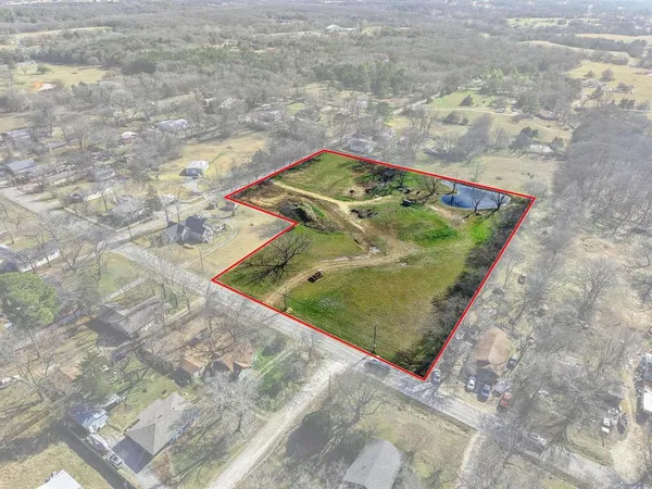 an aerial view of a residential houses with outdoor space
