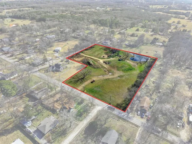 an aerial view of a residential houses with outdoor space