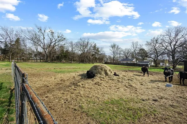 a view of a swimming pool with a patio and a yard