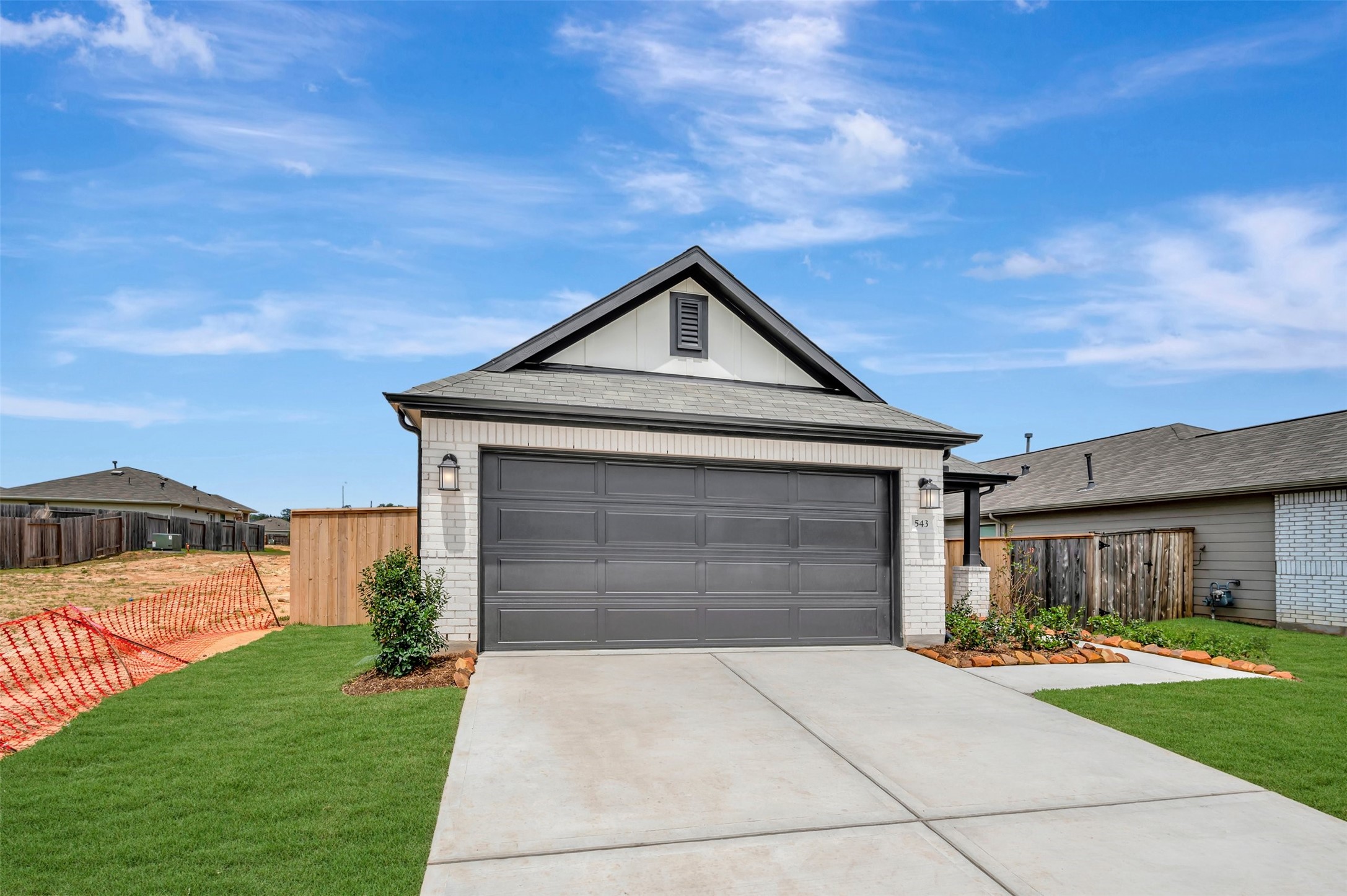 543 Flower Reed Court Magnolia, TX 77354 - Photo 10 of 46 a front view of a house with a yard and garage