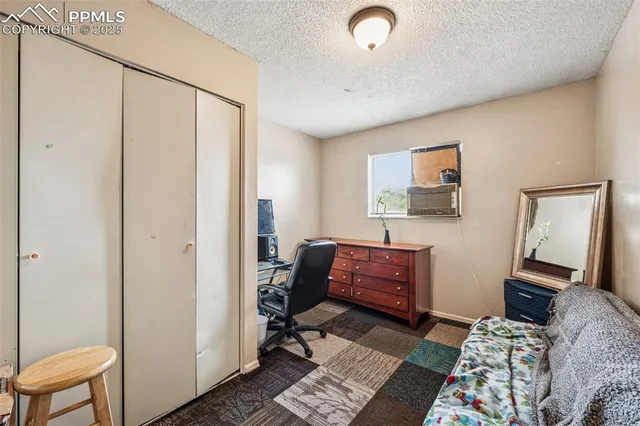 a bedroom with furniture and a window