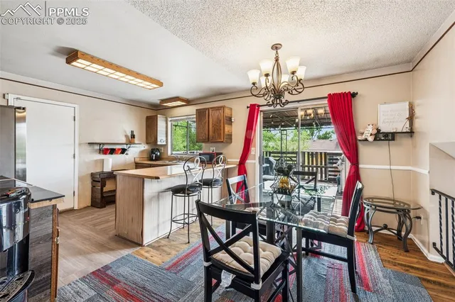 a view of a dining room with furniture wooden floor and chandelier
