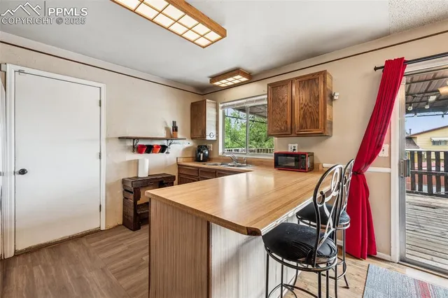 a kitchen with a refrigerator a stove and a wooden floor