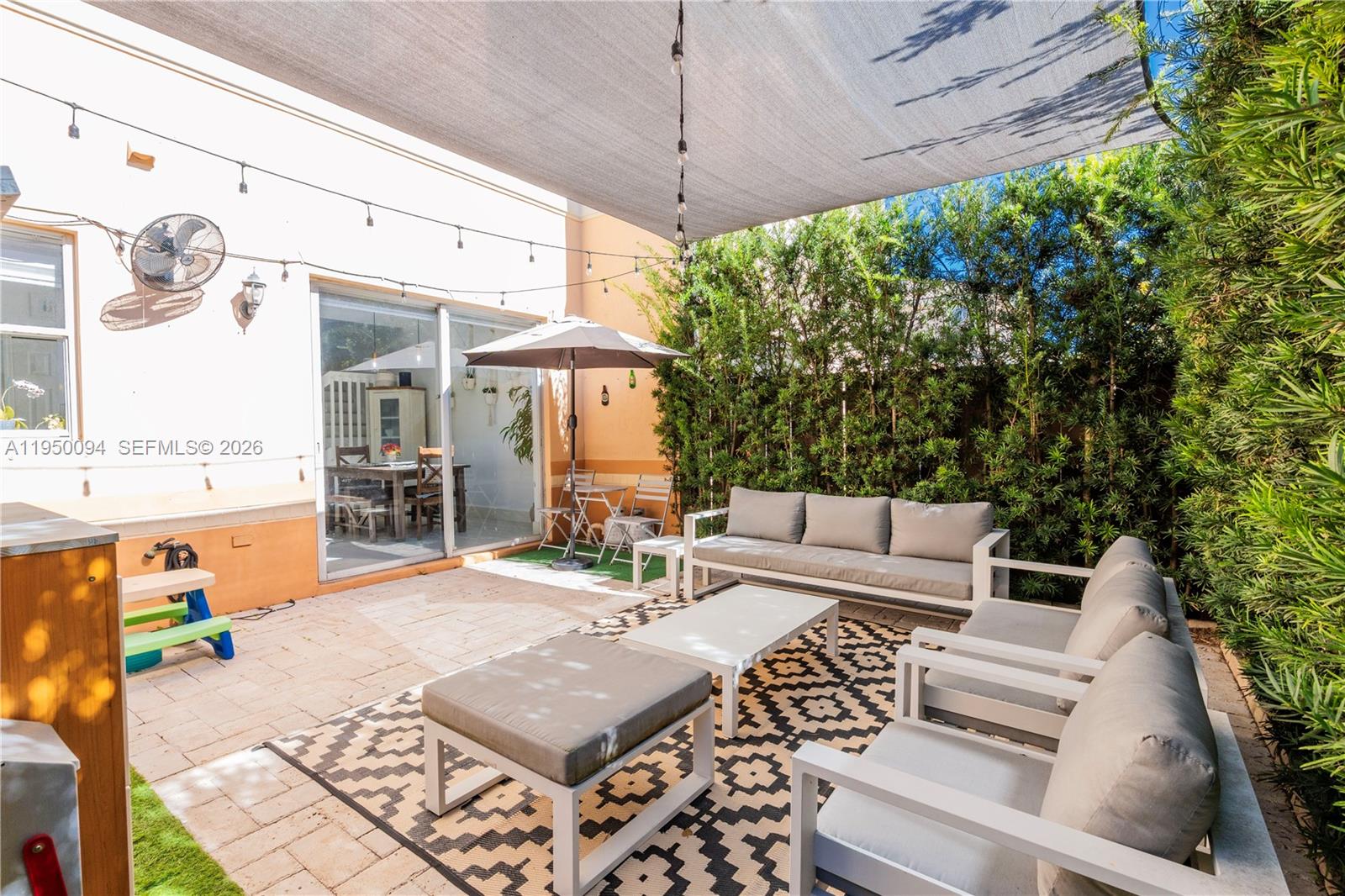12478 Southwest 123rd Street Miami, FL 33186 - Photo 15 of 34 a view of a patio with table and chairs potted plants with wooden floor