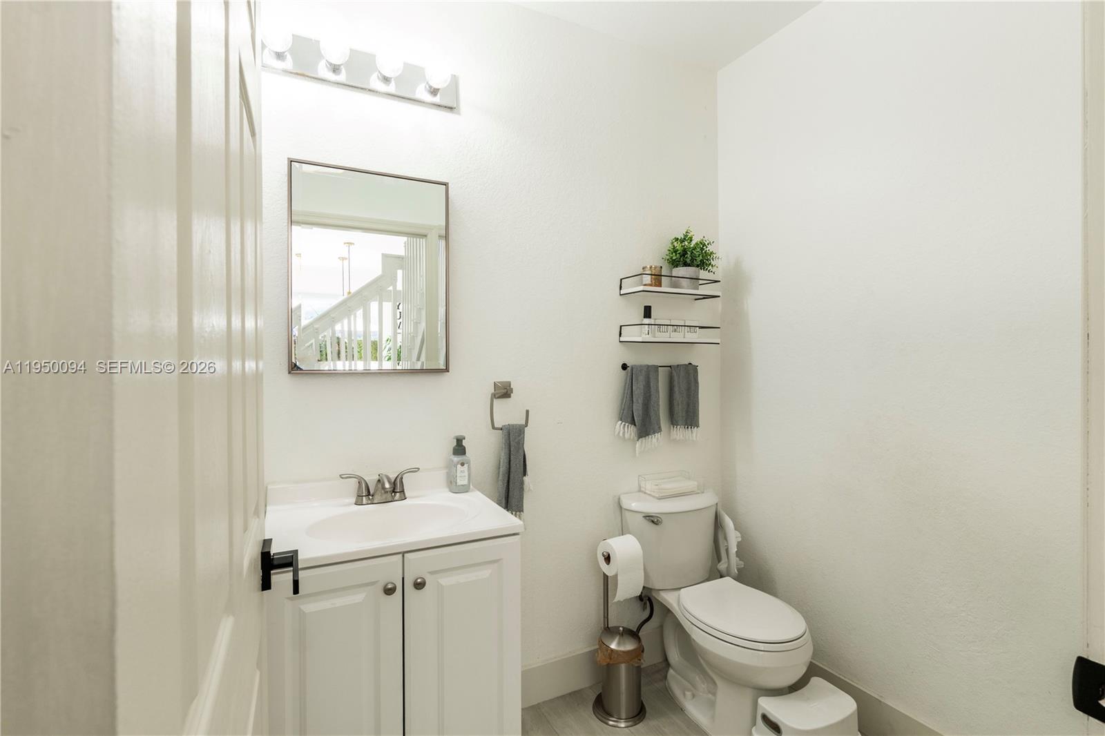12478 Southwest 123rd Street Miami, FL 33186 - Photo 16 of 34 a bathroom with a sink a toilet and mirror