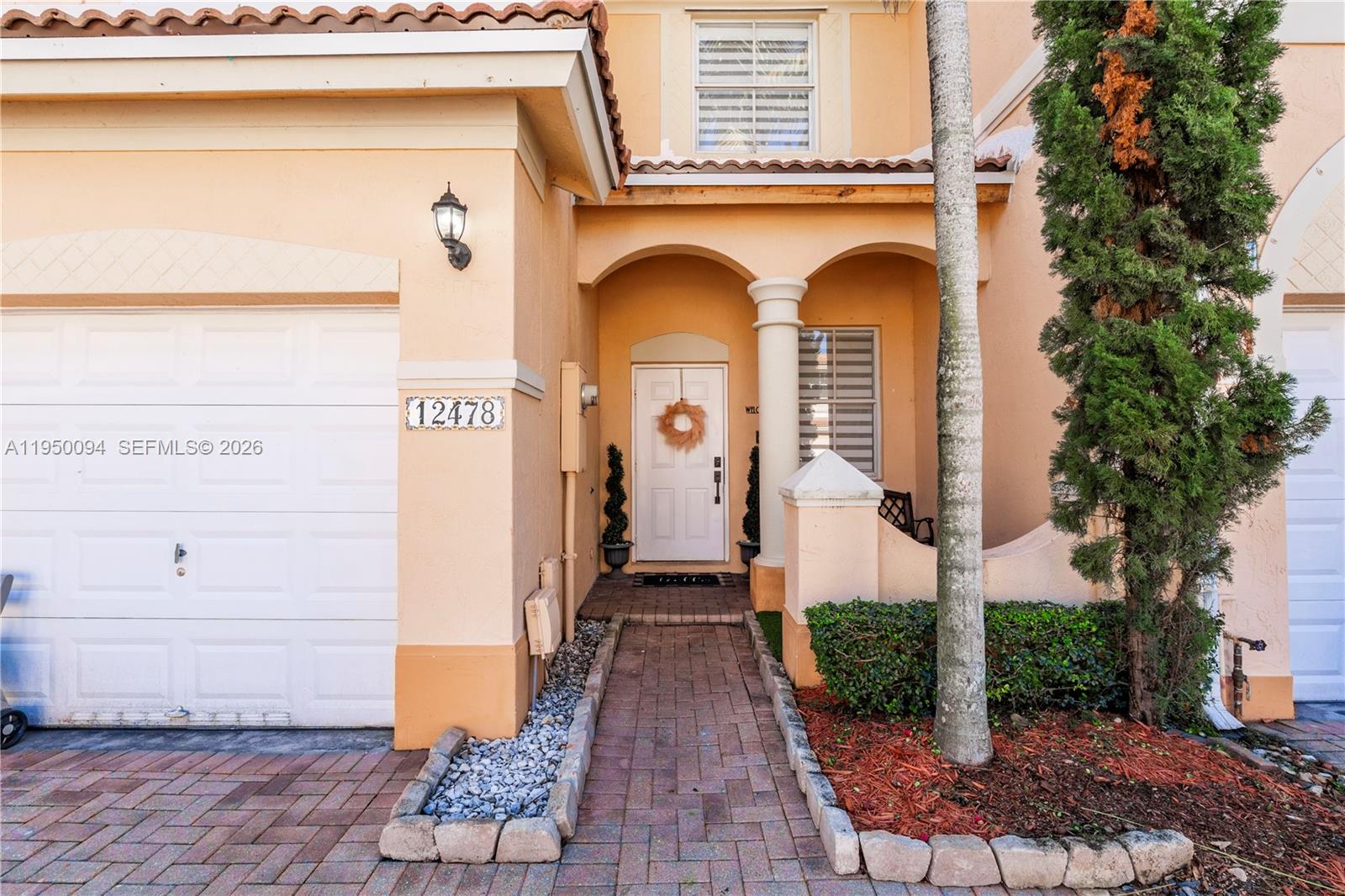 12478 Southwest 123rd Street Miami, FL 33186 - Photo 2 of 34 a front view of a house with garden