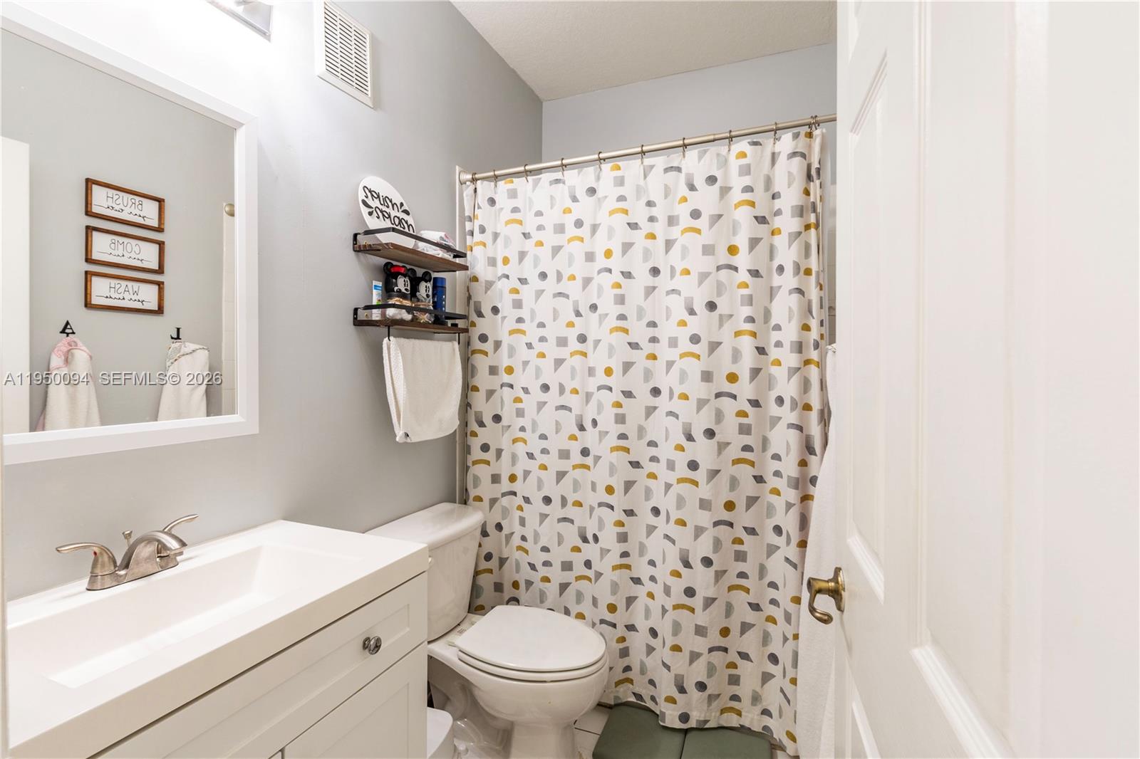 12478 Southwest 123rd Street Miami, FL 33186 - Photo 21 of 34 a bathroom with a sink toilet and shower