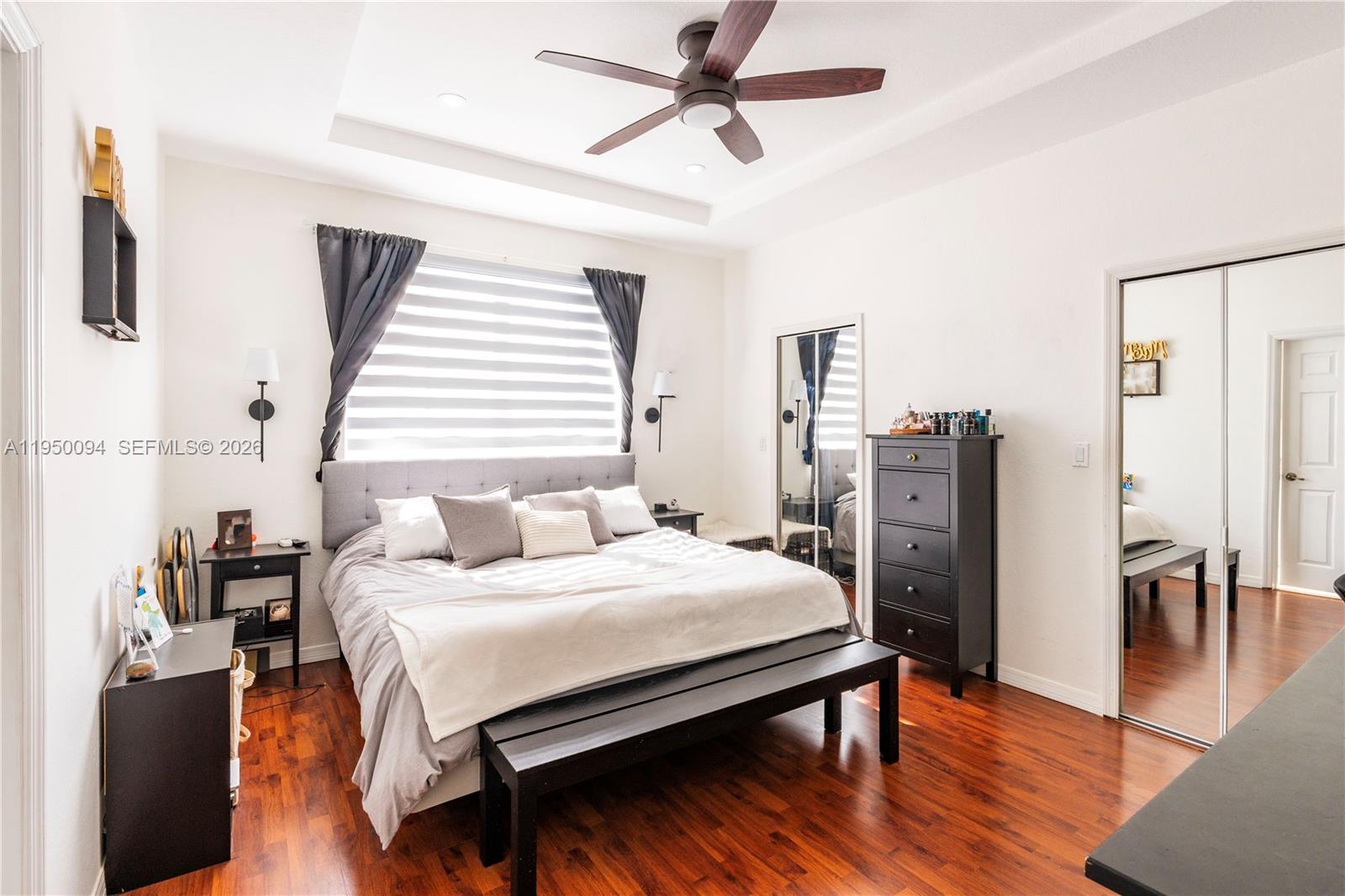 12478 Southwest 123rd Street Miami, FL 33186 - Photo 22 of 34 a bedroom with a bed and wooden floor