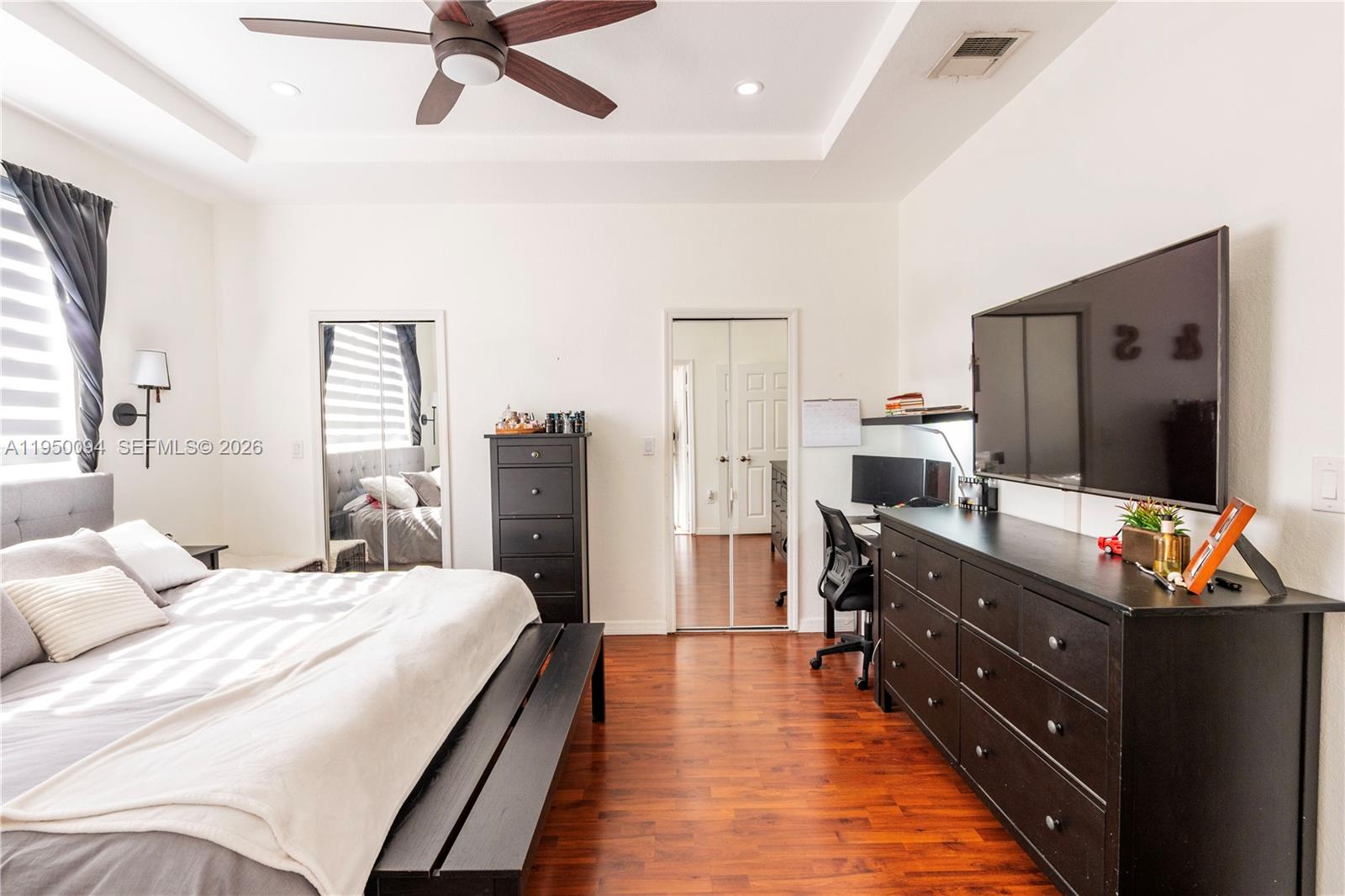 12478 Southwest 123rd Street Miami, FL 33186 - Photo 23 of 34 a bedroom with a bed and a flat screen tv