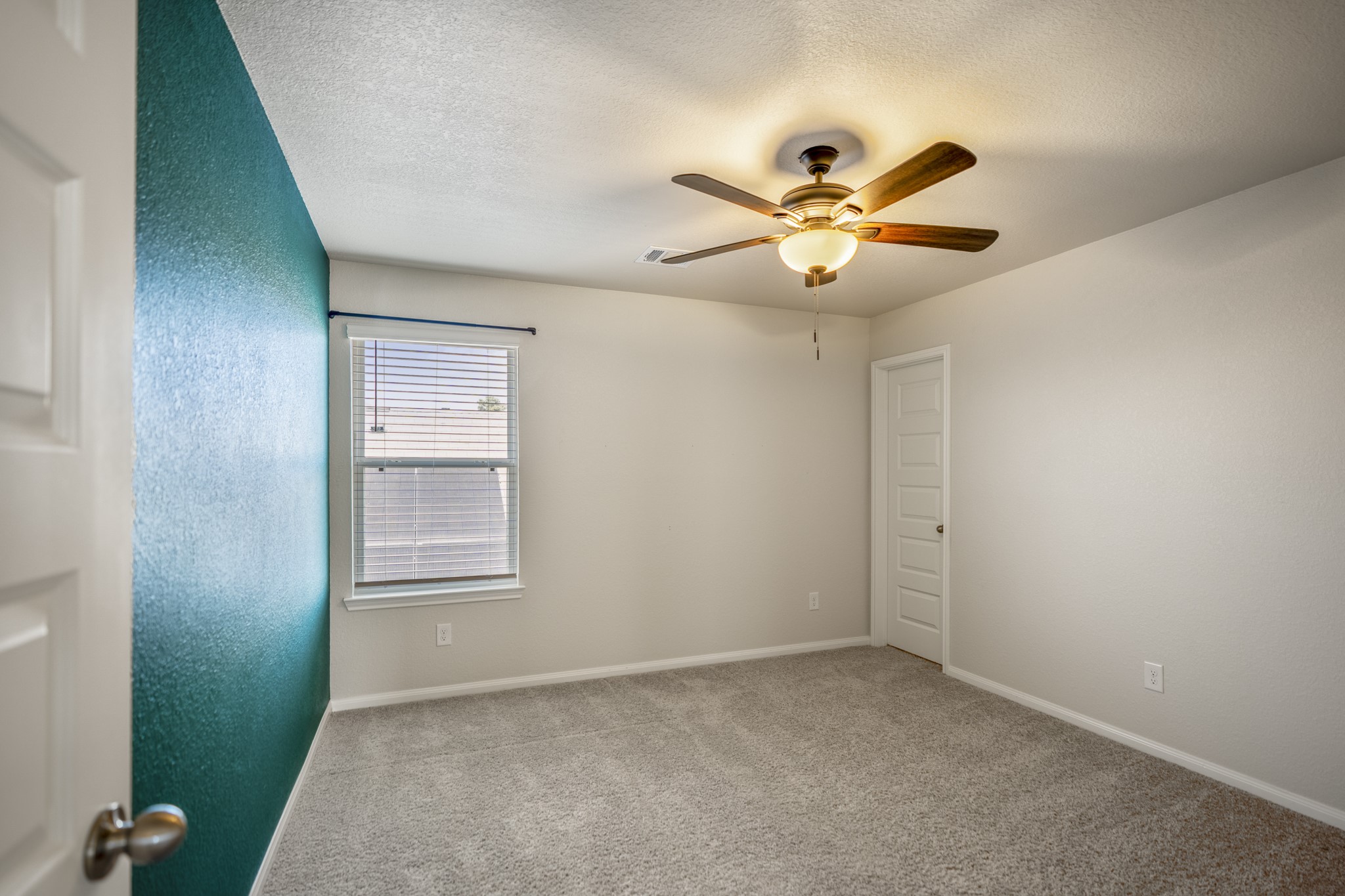 2355 Mount Locke Path Conroe, TX 77301 - Photo 31 of 47 Stepping into the third bedroom, a window brings in natural light while the ceiling fan adds everyday comfort overhead. This room continues the generous upstairs layout, with another impressively spacious closet adding the kind of storage that really stands out throughout the home.