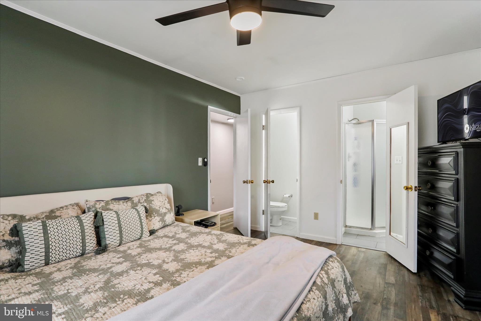 7879 Talhelm Road Chambersburg, PA 17202 - Photo 13 of 43 a bedroom with a large bed and a flat tv screen