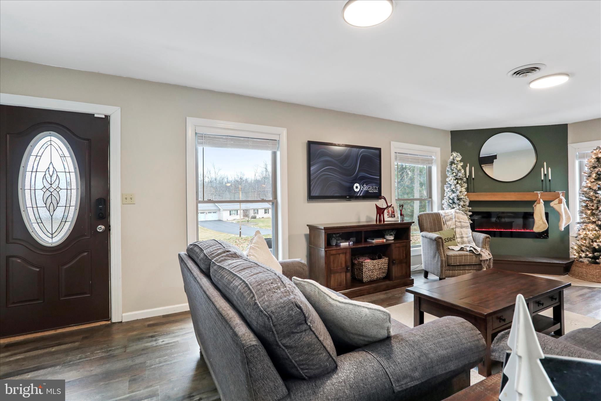7879 Talhelm Road Chambersburg, PA 17202 - Photo 6 of 43 a living room with furniture a fireplace and a flat screen tv