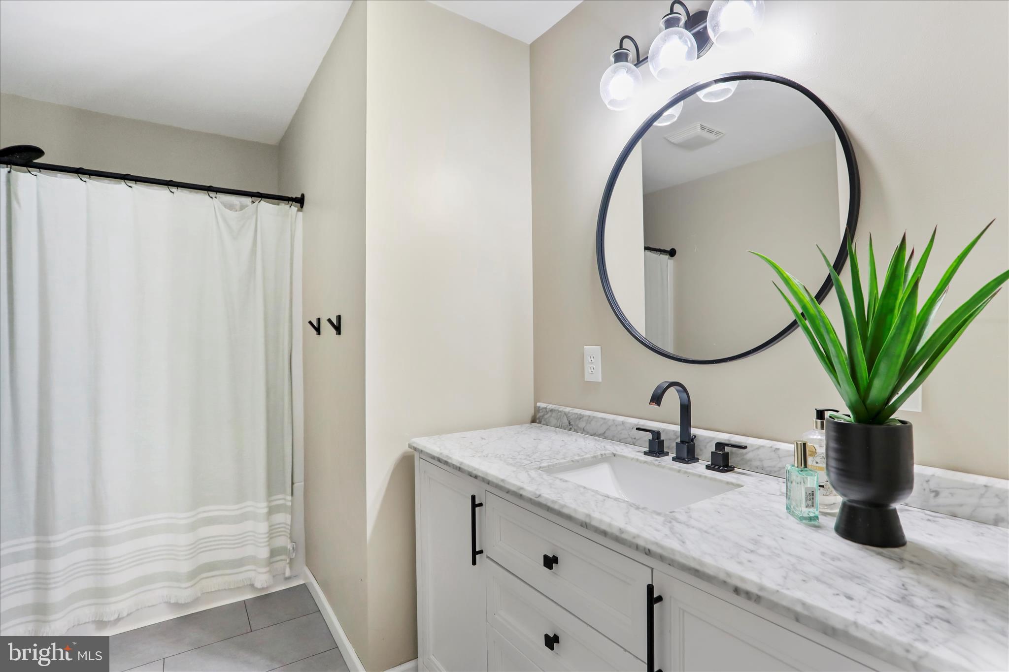 7879 Talhelm Road Chambersburg, PA 17202 - Photo 9 of 43 a bathroom with a granite countertop sink a mirror and vanity