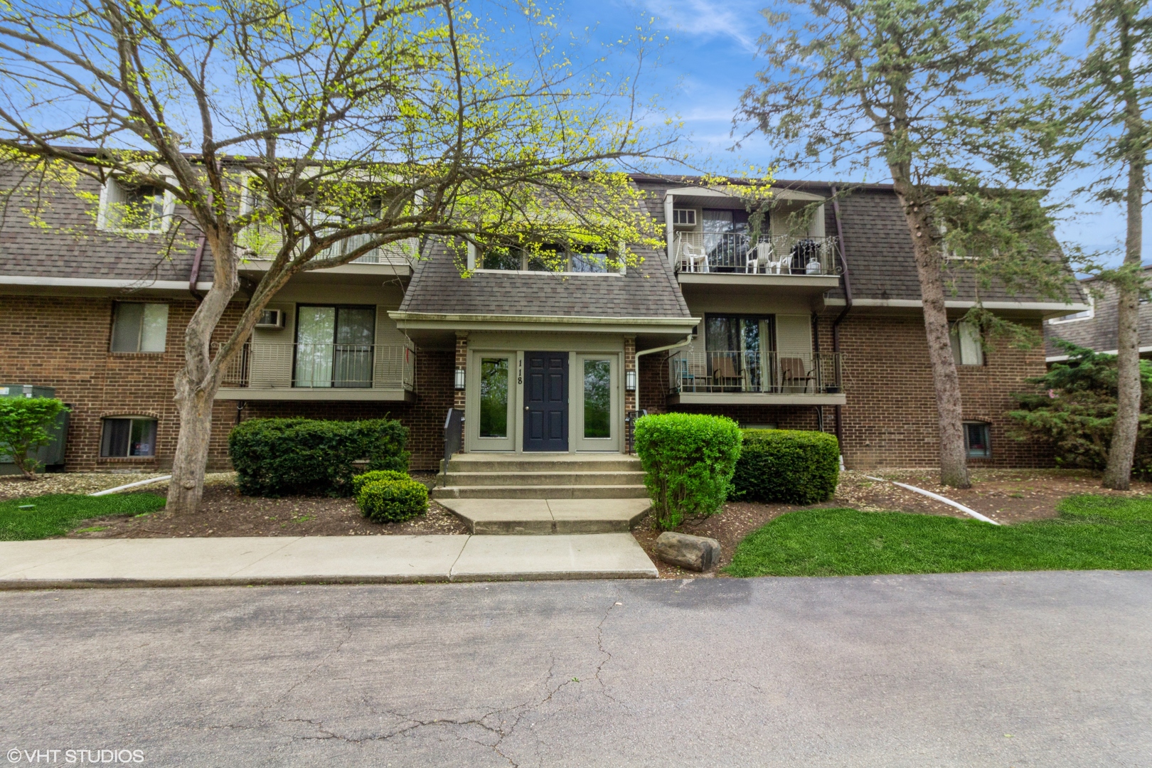 118 East Bailey Road, Unit D Naperville, IL 60565 - Photo 1 of 15 a front view of a house with garden