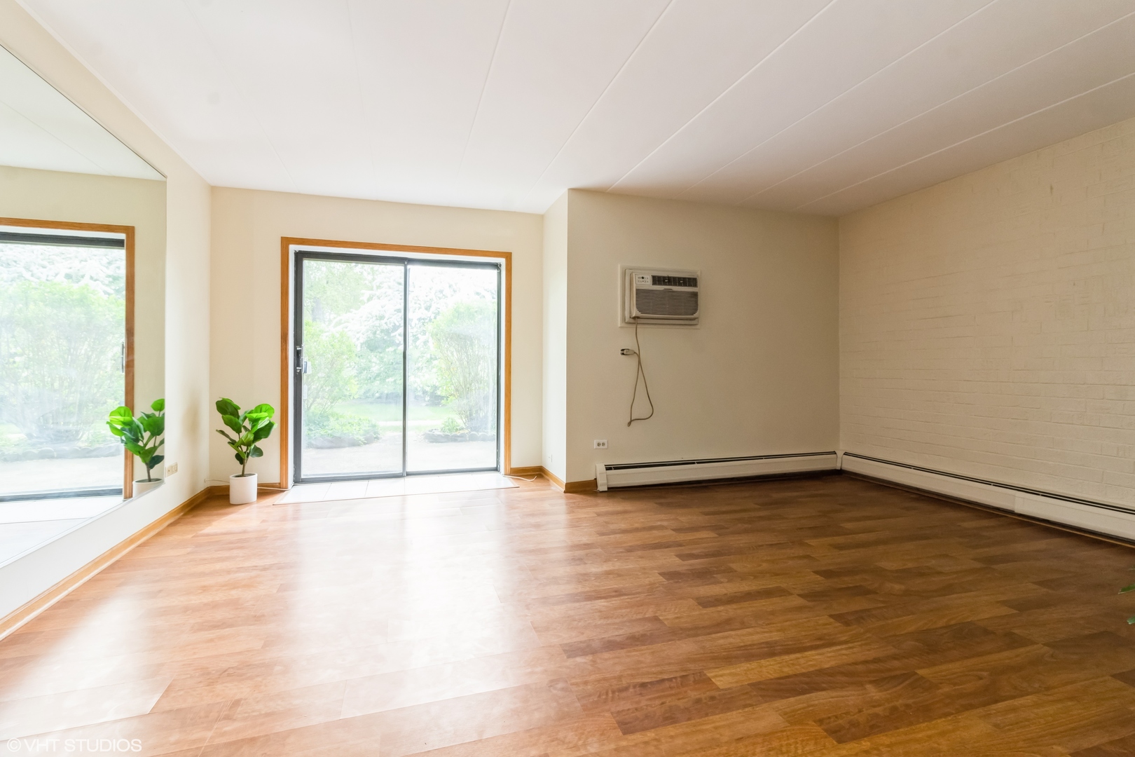 118 East Bailey Road, Unit D Naperville, IL 60565 - Photo 5 of 15 a view of an empty room with glass door and wooden floor