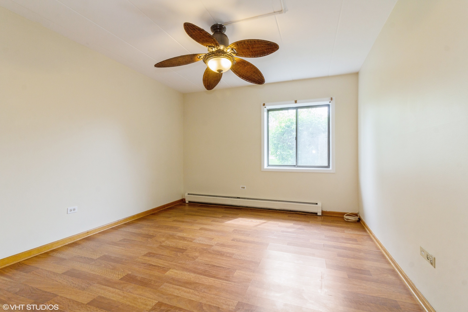 118 East Bailey Road, Unit D Naperville, IL 60565 - Photo 8 of 15 an empty room with wooden floor fan and windows