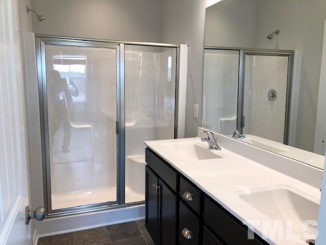 Undisclosed Address Wake Forest, NC 27587 - Photo 13 of 15 a bathroom with a sink and a mirror