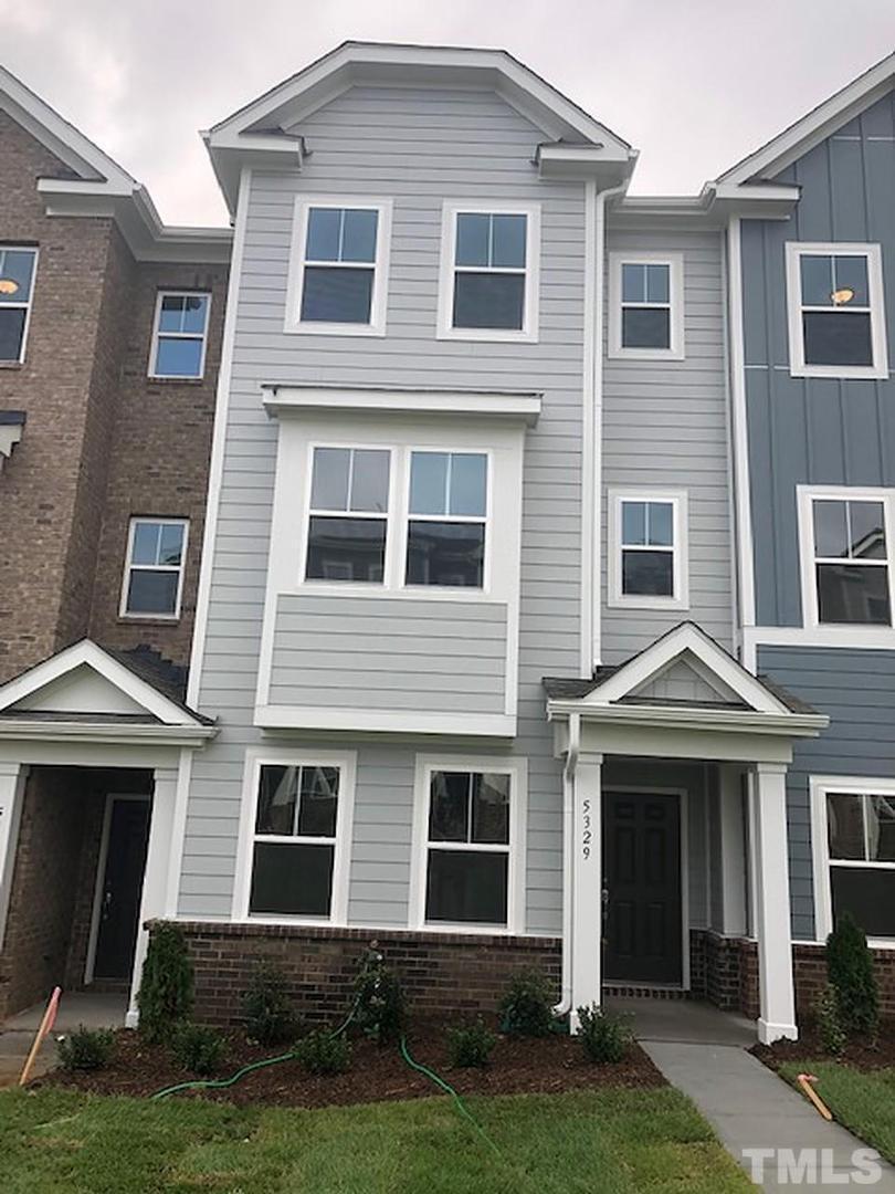Undisclosed Address Wake Forest, NC 27587 - Photo 3 of 15 a front view of a house with a yard and a garage