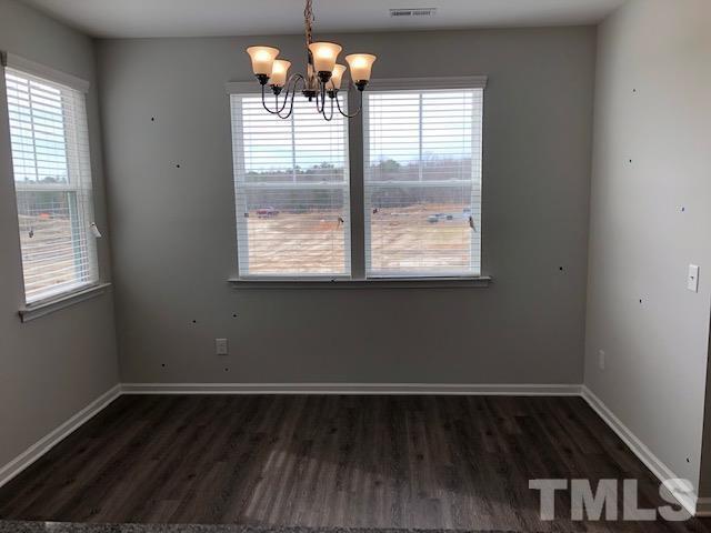 Undisclosed Address Wake Forest, NC 27587 - Photo 6 of 15 an empty room with wooden floor and windows
