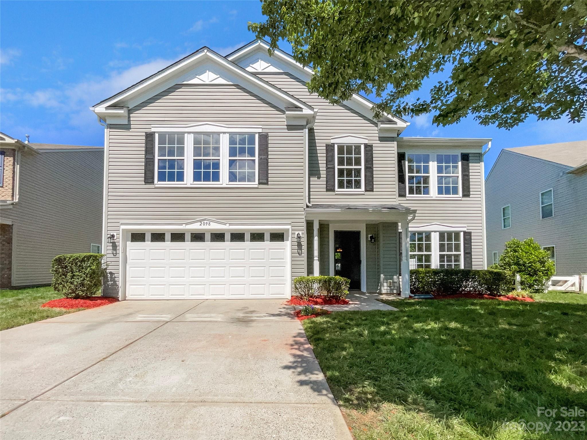 2098 Durand Road Fort Mill, SC 29715 - Photo 1 of 21 a front view of a house with a yard and garage