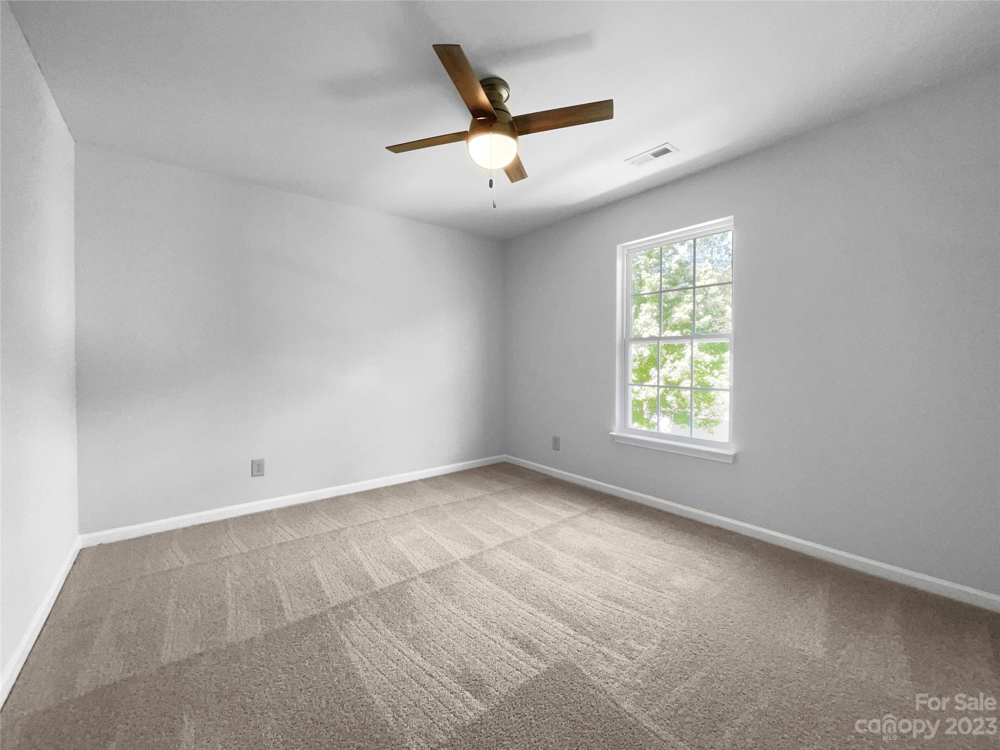 2098 Durand Road Fort Mill, SC 29715 - Photo 5 of 21 an empty room with ceiling fan and window