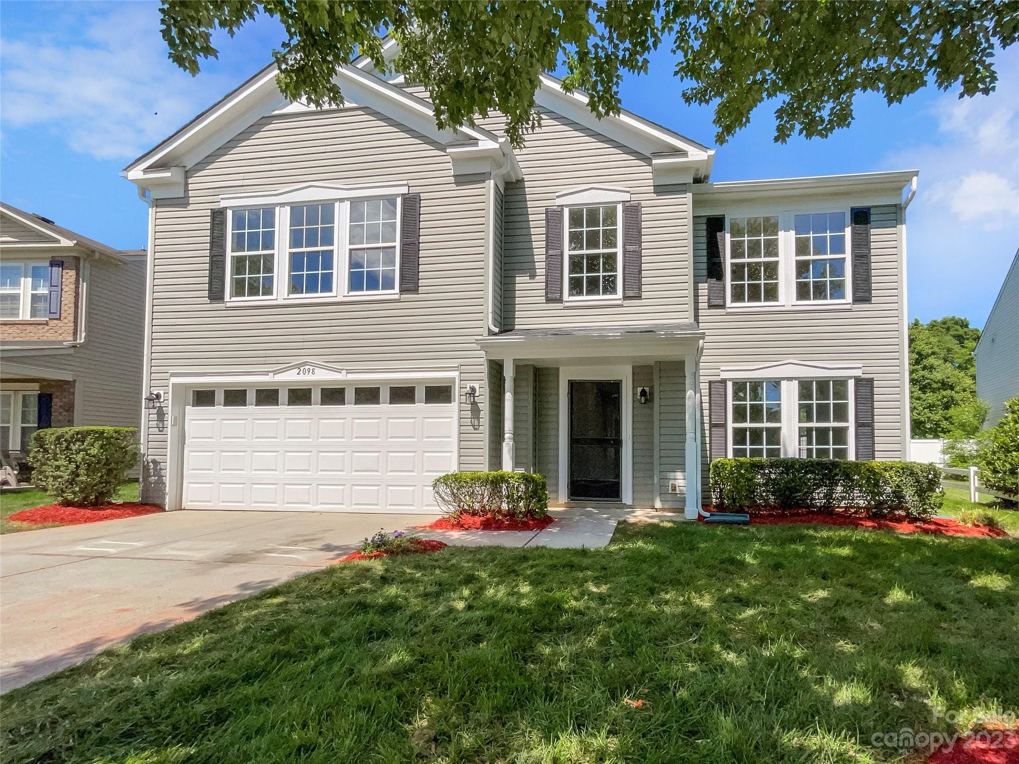 2098 Durand Road Fort Mill, SC 29715 - Photo 6 of 21 a front view of a house with a yard and garage