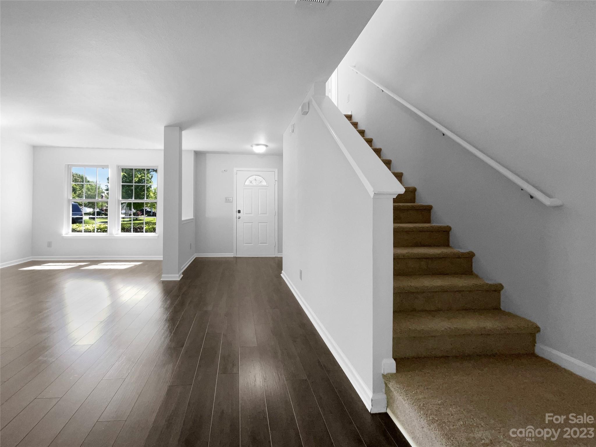 2098 Durand Road Fort Mill, SC 29715 - Photo 7 of 21 a view of an entryway with wooden floor and stairs