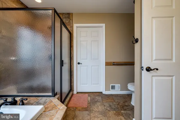a bathroom with a toilet sink and shower