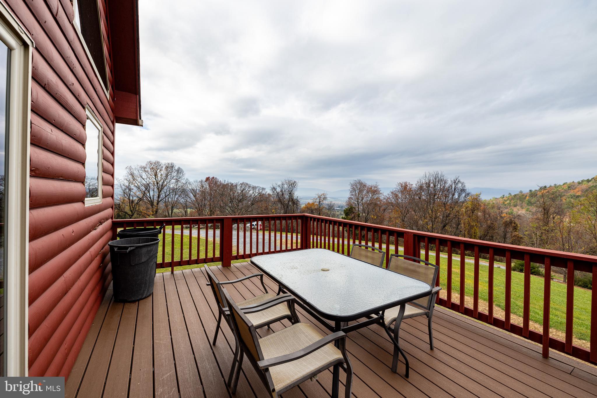 2225 Valley Burg Road Luray, VA 22835 - Photo 36 of 74 a view of a balcony with wooden floor table and chairs